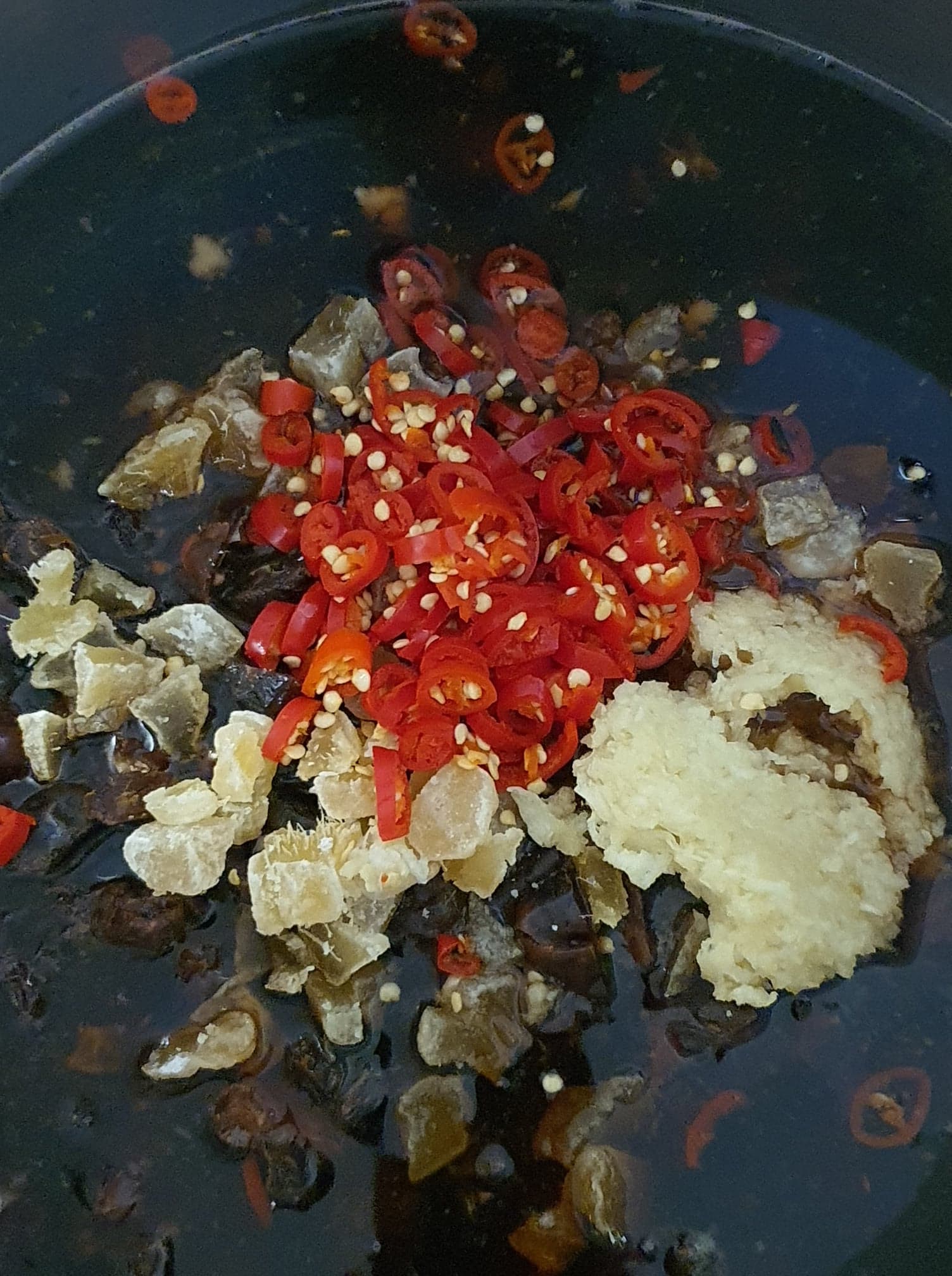 Image of adding all the ingredients except mangoes into the preserving pan.